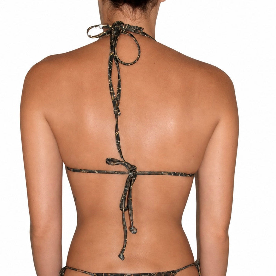 Rear view of a model wearing a camouflage print string bikini against a plain white background.